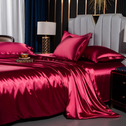 moregrowth101 Washed Silk Four-Piece Bedding Set showcasing luxurious navy silk sheets and elegant pillows on a stylish bed.