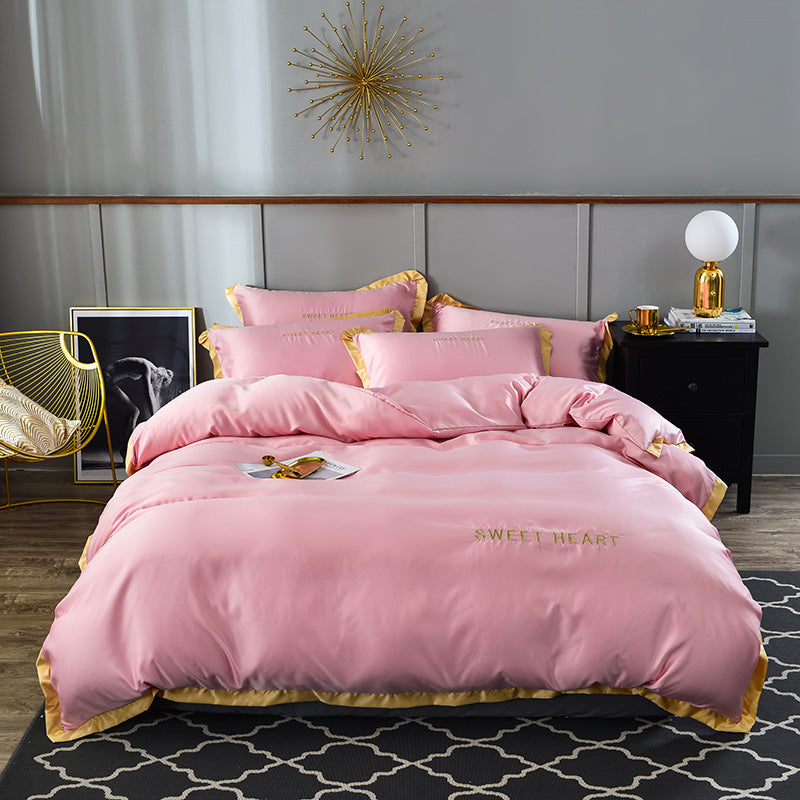 moregrowth101 Washed Silk Bed Sheet in pink with gold trim, luxury bedding for an elegant bedroom.