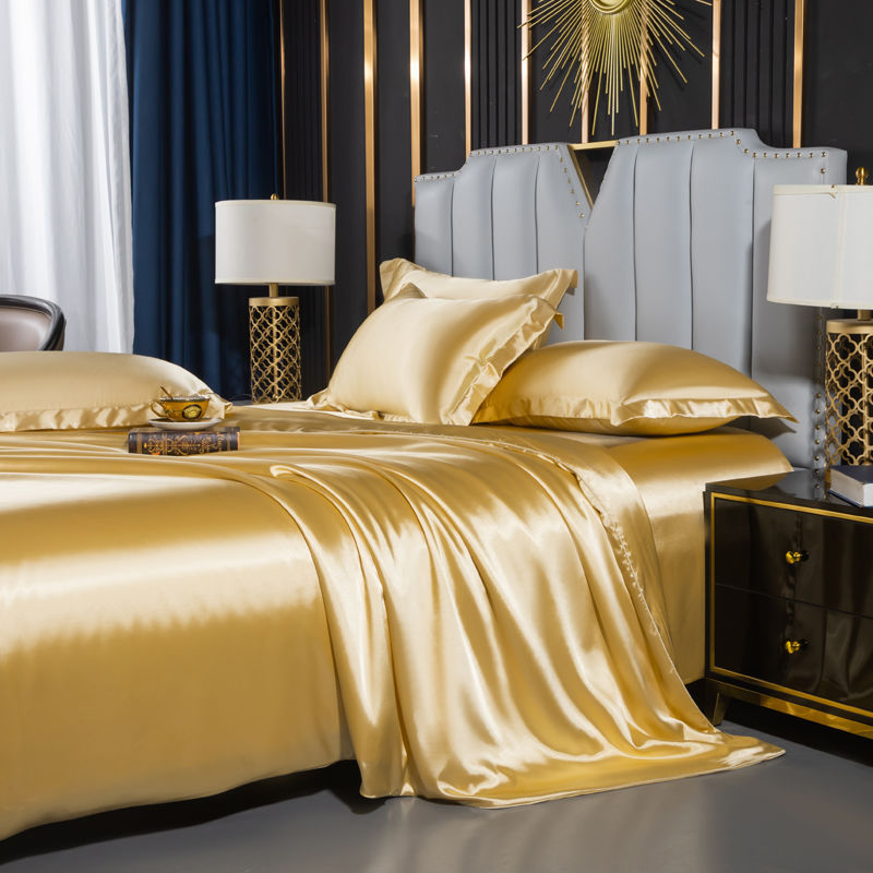 moregrowth101 Washed Silk Four-Piece Bedding Set in luxurious gold color, styled elegantly on a modern bed.