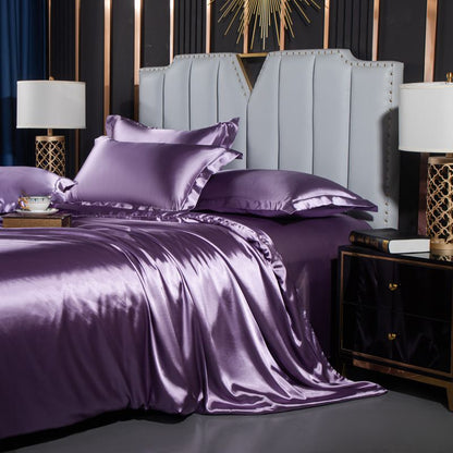 moregrowth101 Washed Silk Four-Piece Bedding Set in purple displayed on a stylish bed with elegant headboard and lamps.