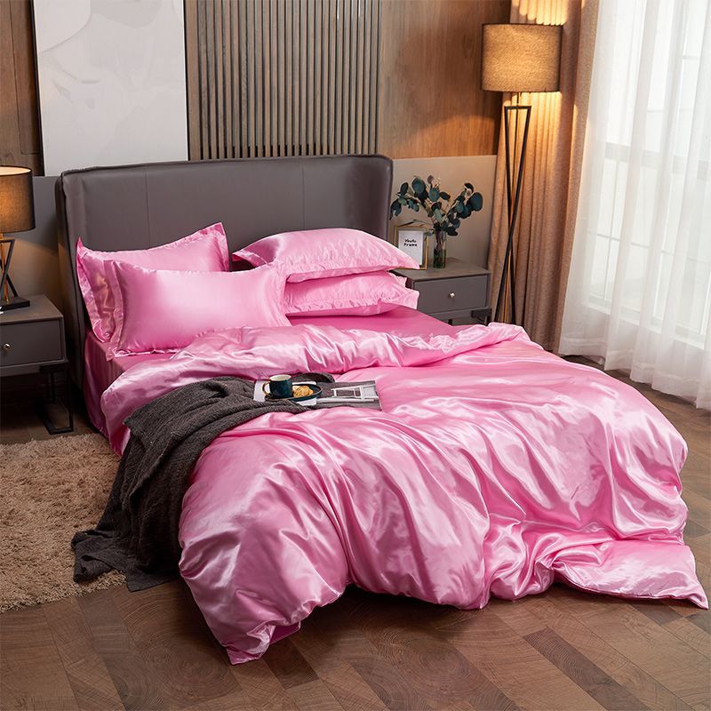 moregrowth101 Washed Silk Four-Piece Bedding Set showcasing luxurious navy silk sheets and elegant pillows on a stylish bed.