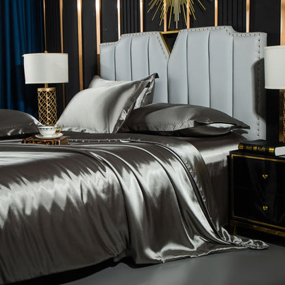 Washed Silk Four-Piece Bedding by moregrowth101 featuring elegant grey sheets and stylish headboard in a luxurious bedroom.