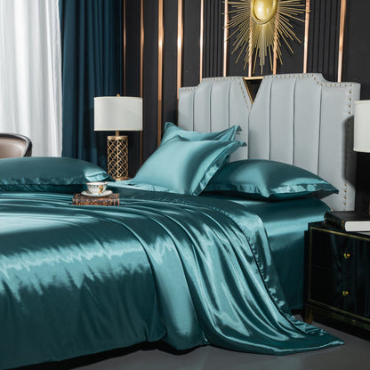 Washed Silk Four-Piece Bedding by moregrowth101 in elegant teal color, styled for a luxurious bedroom atmosphere.